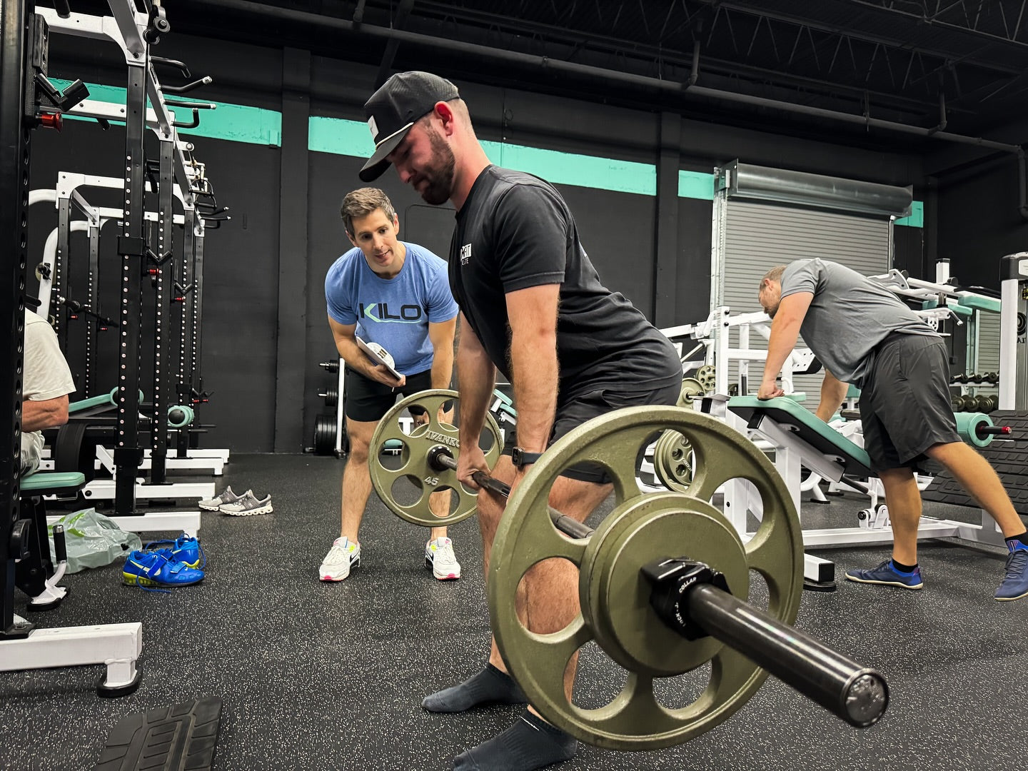 Group workout class with people performing strength exercises